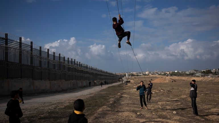 Palestinians displaced by the Israeli bombardment of the northern Gaza...