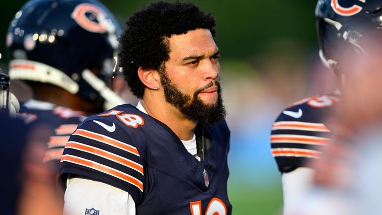 Chicago Bears quarterback Caleb Williams (18) stands on the sideline...