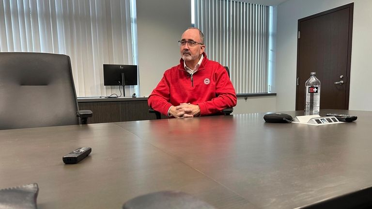 United Auto Workers President Shawn Fain speaks to a reporter...