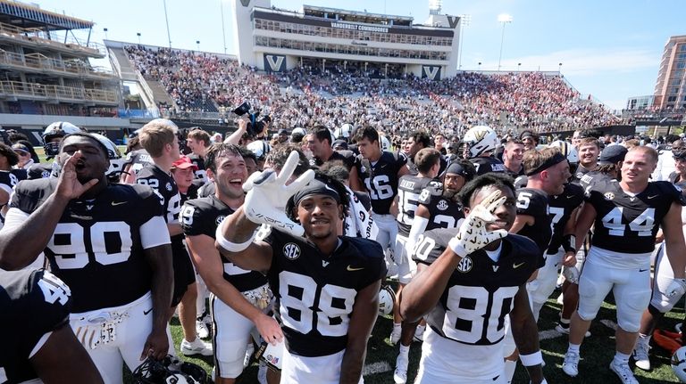 Vanderbilt players celebrate the team's 34-27 overtime win after an...