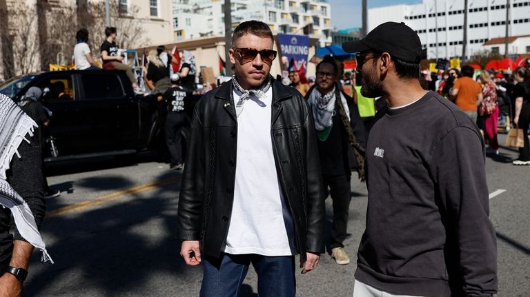 U.S. rapper Macklemore, center, attends a demonstration in support of...