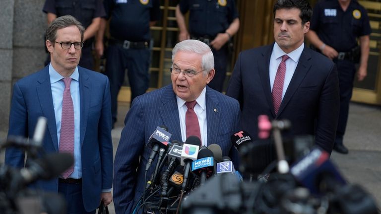 Sen. Bob Menendez, D-N.J., center, speaks to reporters as he...