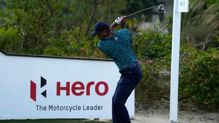 Tiger Woods tees off on the third hole during the...