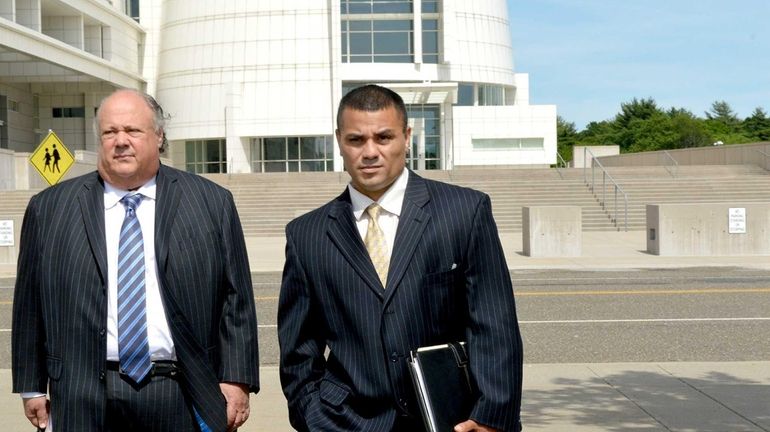 Bryan Arias, right, and his lawyer Richard A. Librett leave...