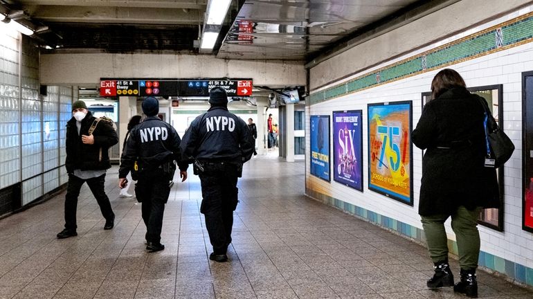 NYPD officers patrol the Times Square subway station in Manhattan...