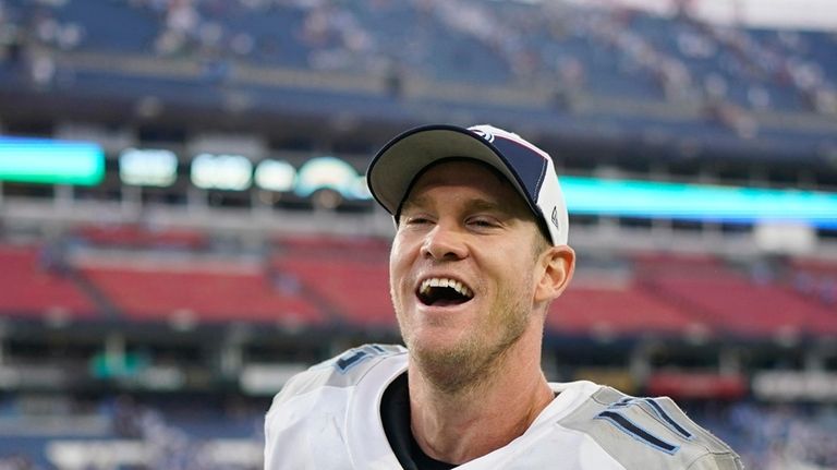 Tennessee Titans quarterback Ryan Tannehill smiles as he walks off...