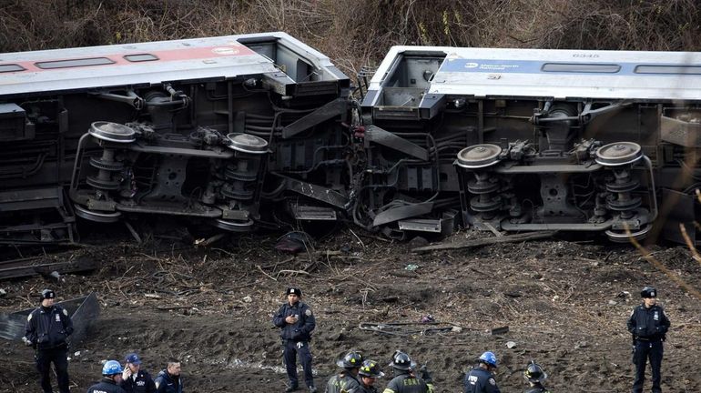 Emergency personnel respond to the scene of a Metro-North passenger...