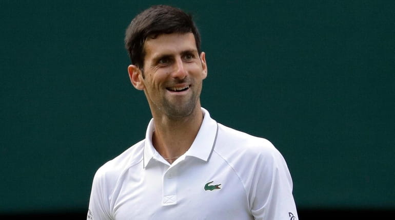 Serbia's Novak Djokovic smiles after defeating Switzerland's Roger Federer during...