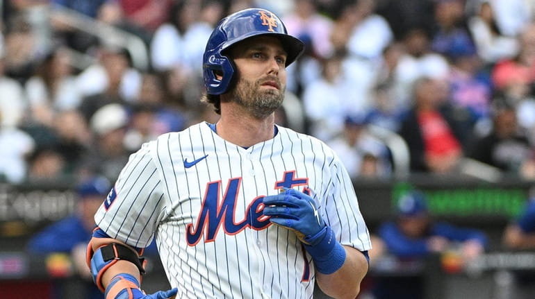Mets’ Jeff McNeil looks on after flying out to end...