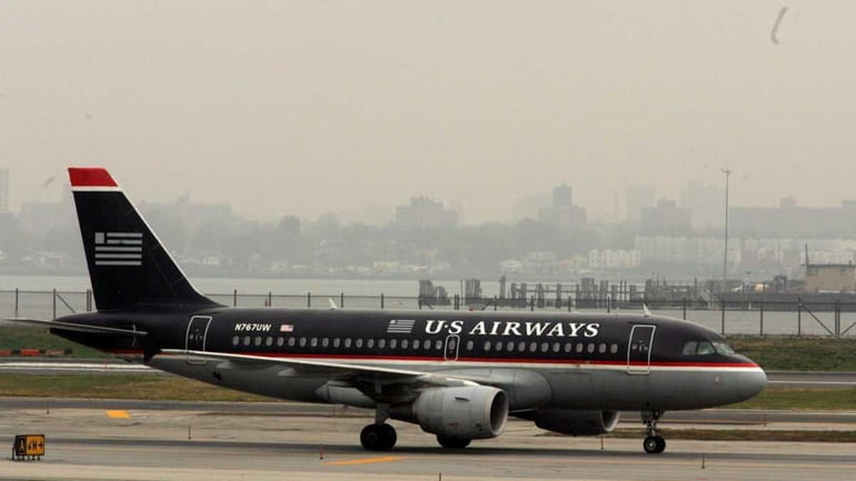 A US Airways jet airplane is seen taxiing on a...