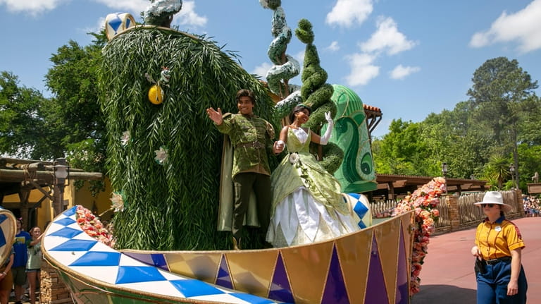 Actors dressed as Princess Tiana and Prince Naveen from The...