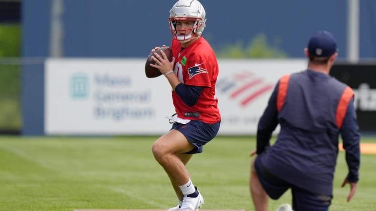 New England Patriots quarterback Drake Maye performs drills during an...