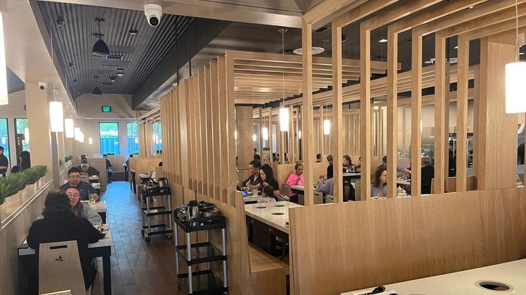 Spring Shabu-Shabu in Westbury has Japanese-style wood paneled dividers between...