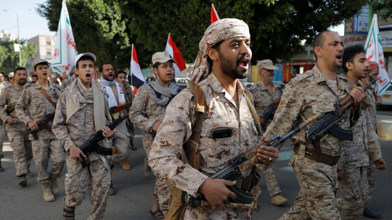 Houthi supporters march marking the anniversary of Yemeni unity in...