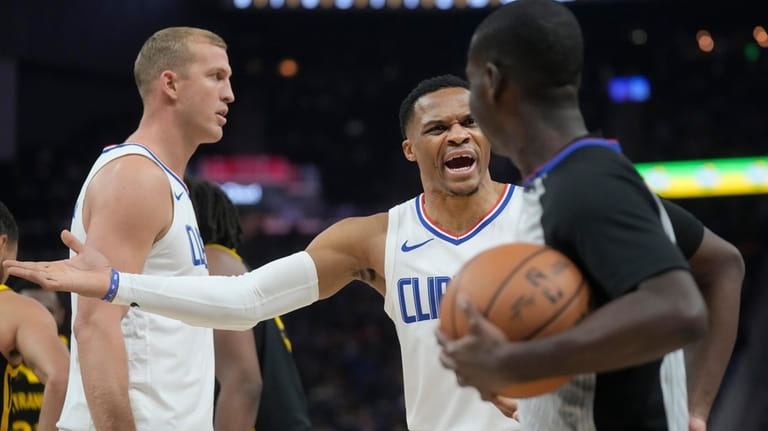 Los Angeles Clippers guard Russell Westbrook, middle, reacts toward referee...