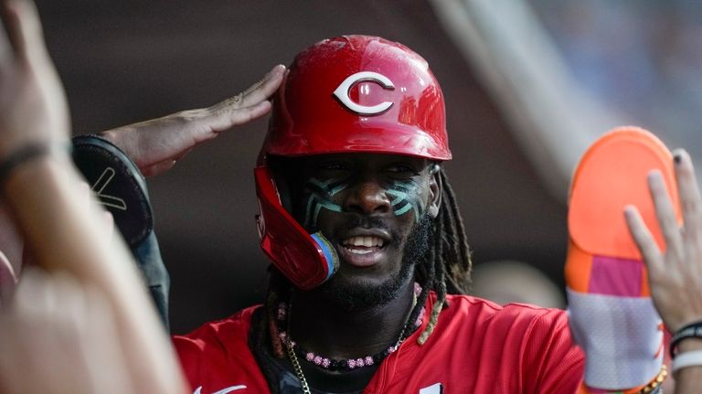 Cincinnati Reds' Elly De La Cruz celebrates in the dugout...