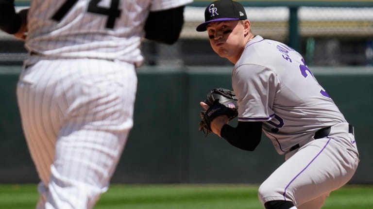 Colorado Rockies second baseman Aaron Schunk, right, throws out Chicago...