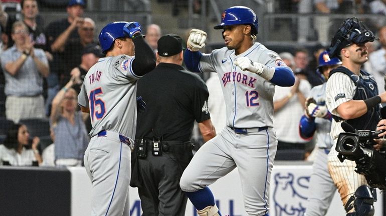 The Mets’ Tyrone Taylor greets Francisco Lindor after both score...