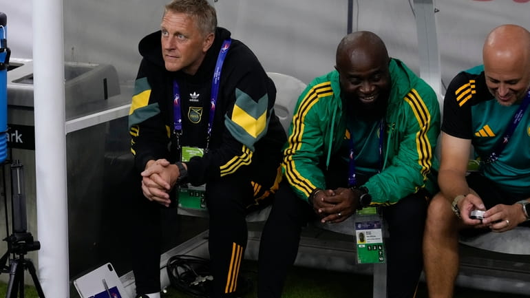 Jamaica's coach Heimir Hallgrimsson, left, sits on the bench prior...