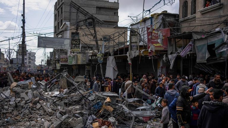 Palestinians check destruction after an Israeli strikea in Rafah, Gaza...