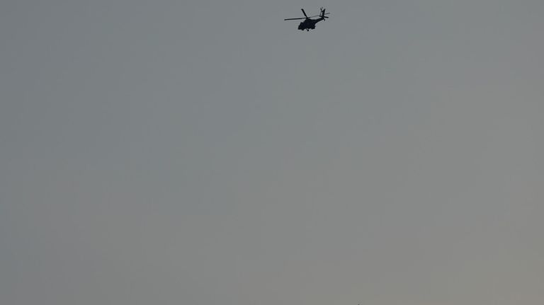 Israeli Apache helicopters fly toward northern Israel, Sunday, Aug. 25,...