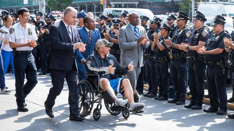 NYPD Sgt. Carl Johnson, of Queens, leaves NYC Health + Hospitals/Bellevue...