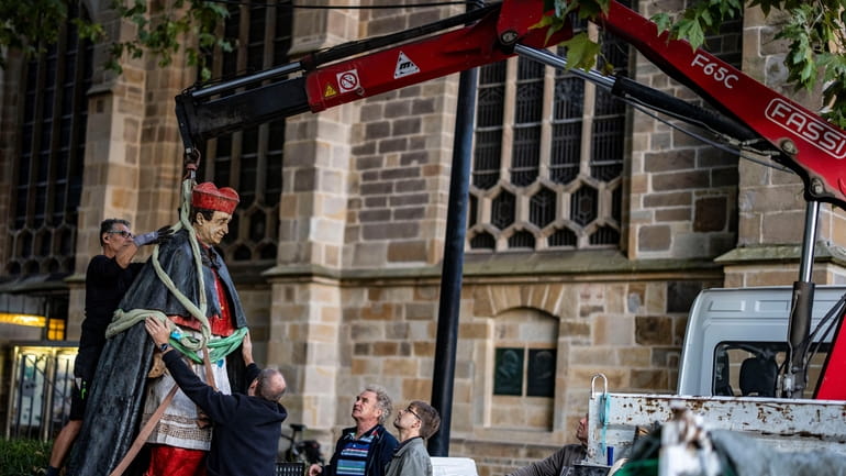 The sculpture of Essen Cardinal Franz Hengsbach hangs on a...