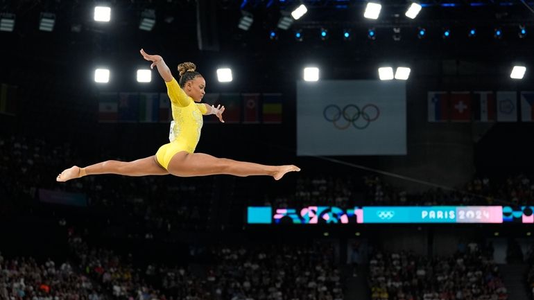 Rebeca Andrade, of Brazil, performs on the balance beam during...