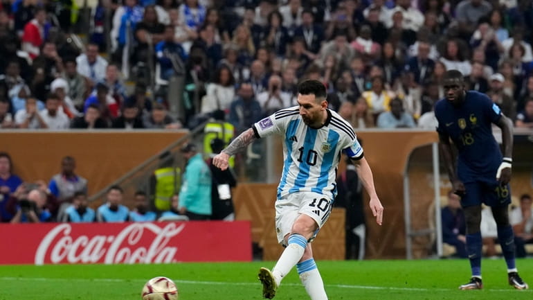 Argentina's Lionel Messi scores the opening goal from the penalty...