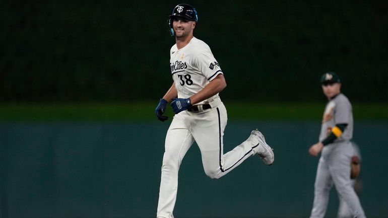 Minnesota Twins' Matt Wallner runs the bases after hitting a...