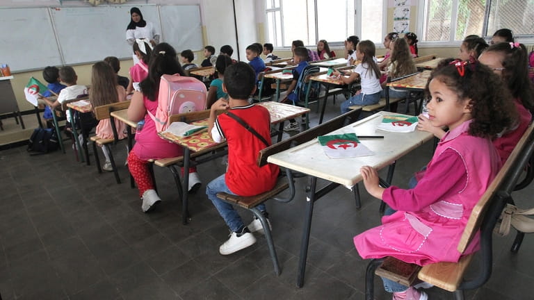 Schoolchildren attend a class in the Ben Omar district of...