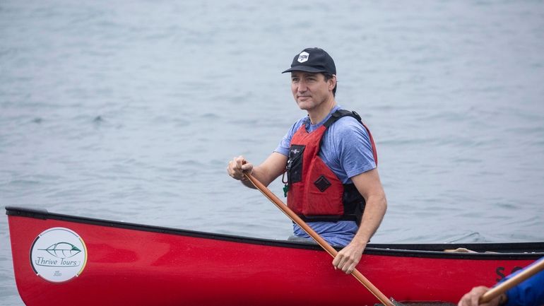 Prime Minister Justin Trudeau canoes with local Indigenous leaders on...