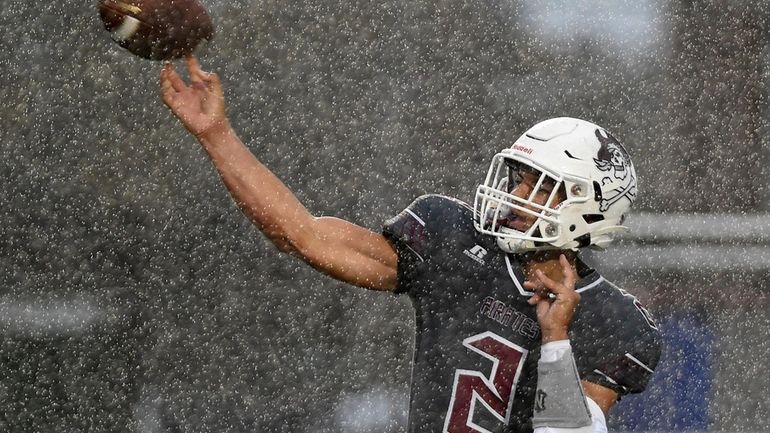 Dominick Novello #2, Mepham quarterback, throws a pass during a...