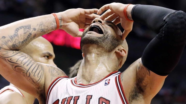 Chicago Bulls forward Carlos Boozer reacts after missing a basket...