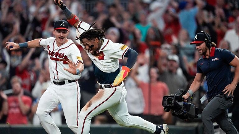 Atlanta Braves' Ronald Acuña Jr. celebrates after scoring the winning...