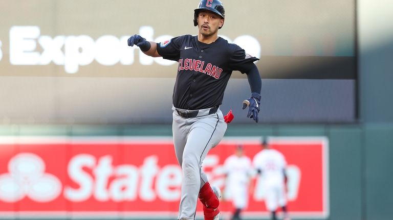 Cleveland Guardians' Steven Kwan celebrates after his solo home run...