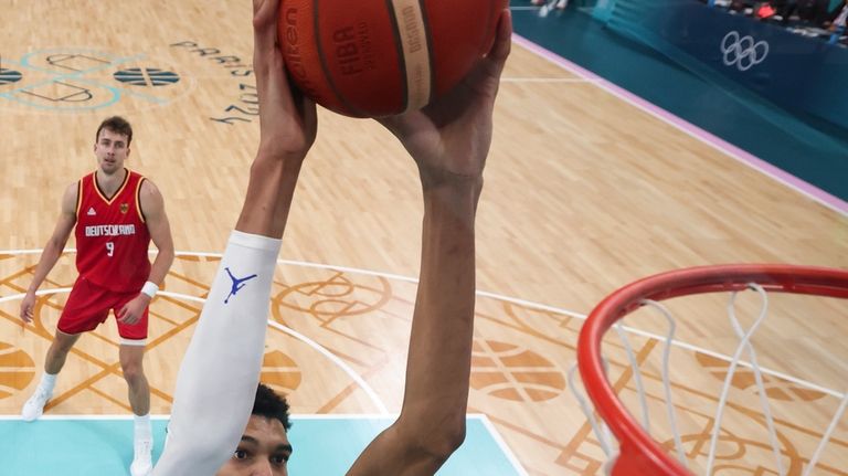 Victor Wembanyama, of France, gets a dunk against Germany in...