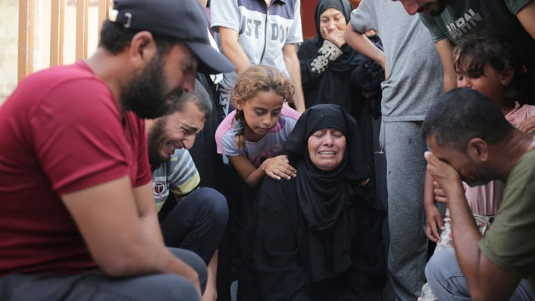 A Palestinian family mourns a loved one killed by Israeli...