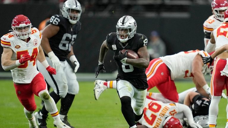 Las Vegas Raiders running back Josh Jacobs (8) runs past...