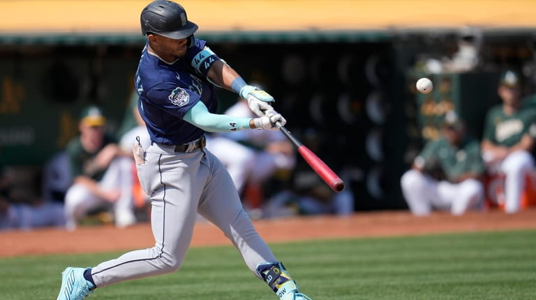 Seattle Mariners' Julio Rodriguez hits a home run against the...