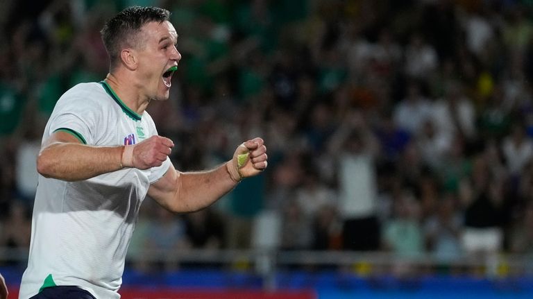 Ireland's Johnny Sexton celebrates after scoring a try during the...