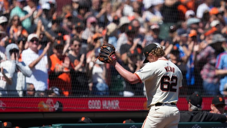 San Francisco Giants pitcher Logan Webb gestures as he exits...