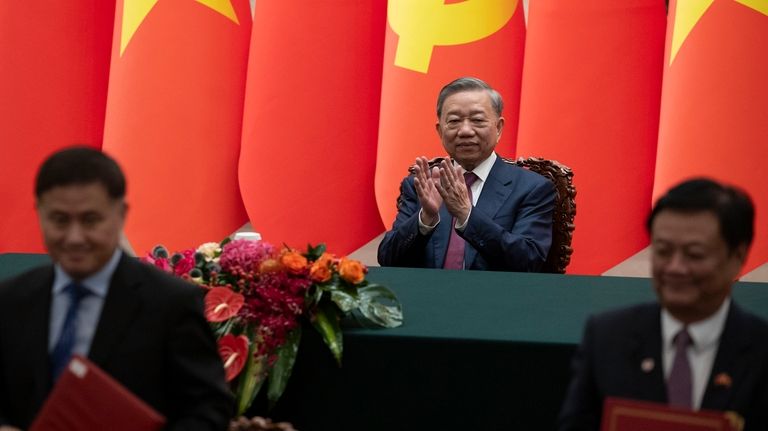 Vietnam's President To Lam, center, applauds during a signing ceremony...