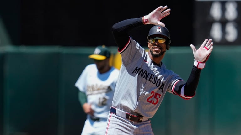 Minnesota Twins' Byron Buxton reacts after hitting a two-run double...