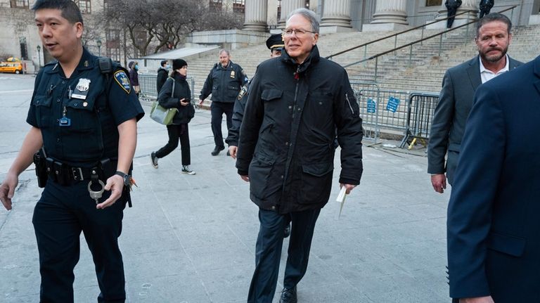 Wayne LaPierre, center, CEO of the National Rifle Association, leaves...