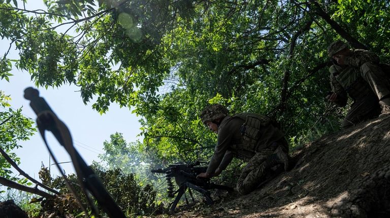 A Ukrainian marine of 35th brigade fires by automatic grenade...