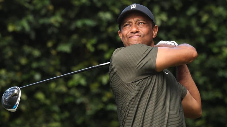 Tiger Woods hits his tee shot on the second hole...