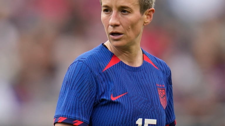 United States forward Megan Rapinoe walks the pitch after missing...