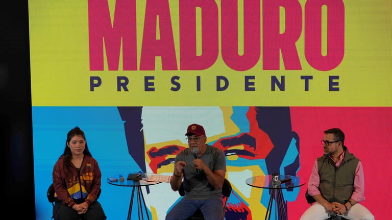 President of Venezuela's National Assembly Jorge Rodriguez, center, speaks during...
