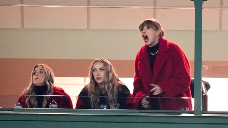 Taylor Swift, right, reacts during the second half of an...